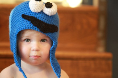 baby wearing a crocheted monster hat
